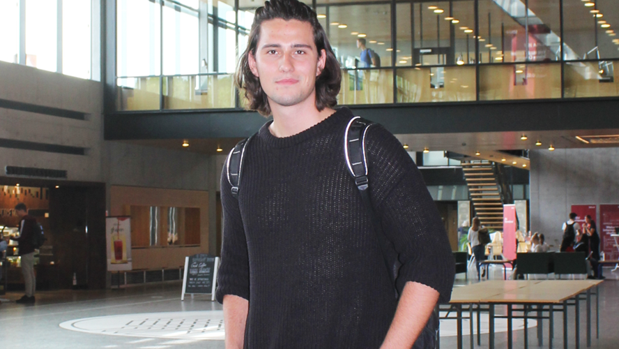 Kristian Bjerre står i en stor hal på Syddansk Universitet 